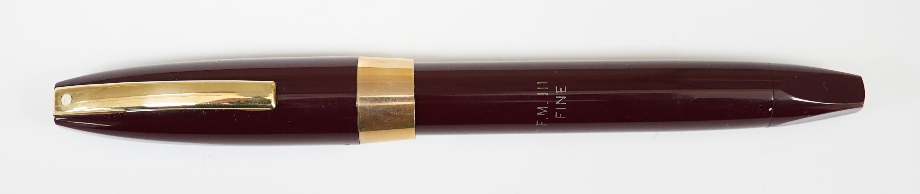 A Sheaffer PFM fountain pen in burgundy, with factory chalk marks to barrel